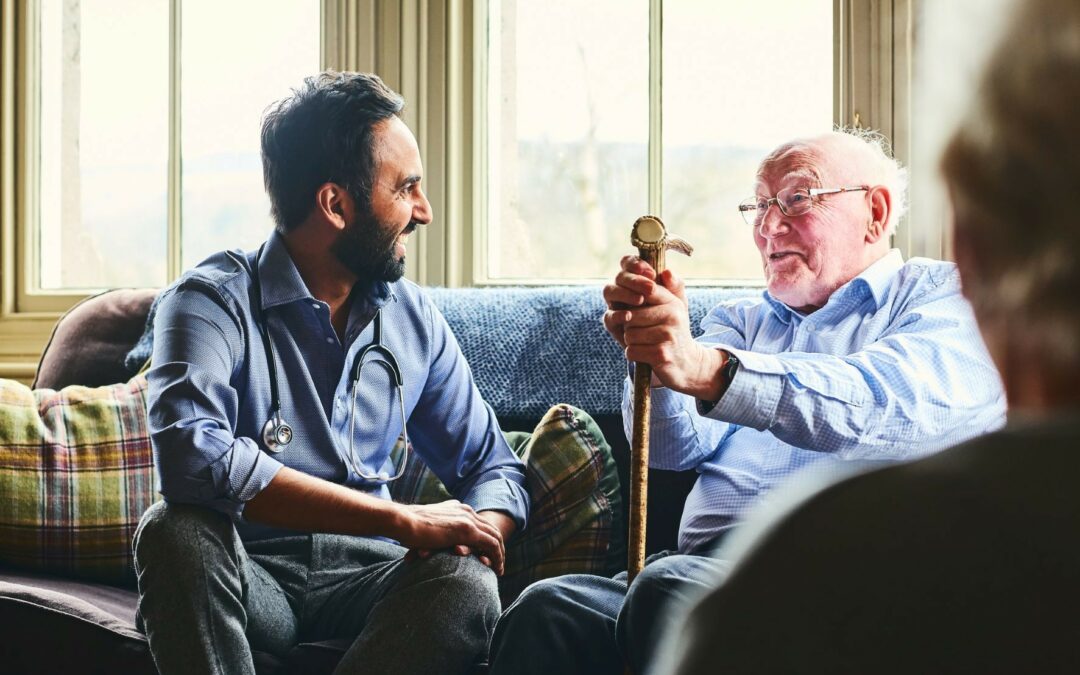 A family member laughs with a hospice patient in hospice care.